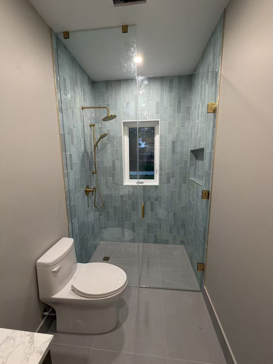 Frameless shower with brass hardware